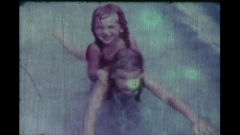 A scratched image of two smiling children in a pool