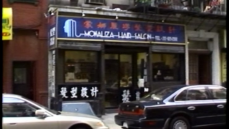 Colour image of a street view of the exterior of a chinese hair salon.