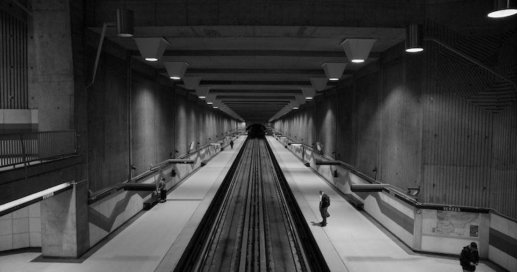 A centered view of the tracks of the Montreal Metro inside of Verdun station in Black and White