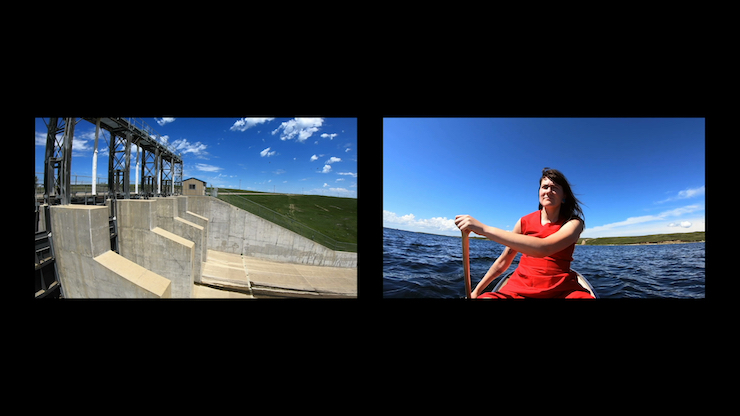 Colour image of a woman in a red dress paddling a canoe, an electrical dam on the left.