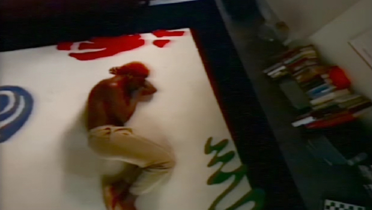 aerial view of a man, shirtless laying on a canvas