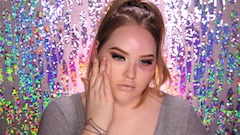 image of person applying makeup against sparkly backdrop