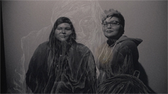 A black and white photo of two young Indigenous women looking at the camera. 
